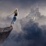 Eine Frau steht auf einem Felsvorsprung und springt ins Ungewisse in Richtung Schloss